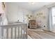 A cozy Bedroom showcasing a gray crib, neutral walls, and a comfortable rocking chair at 4605 Clairmont Dr, Columbus, IN 47203