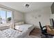 Bright bedroom with a large window, a cozy sofa, a desk, and wood-look floors at 4605 Clairmont Dr, Columbus, IN 47203
