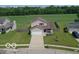 Inviting two-story home with a well-manicured lawn and attached two-car garage at 4605 Clairmont Dr, Columbus, IN 47203
