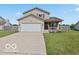 Inviting two-story home with a well-manicured lawn and a convenient two-car garage at 4605 Clairmont Dr, Columbus, IN 47203