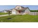 Charming two-story home with a well-maintained lawn and a cozy front porch featuring seasonal decorations at 4605 Clairmont Dr, Columbus, IN 47203