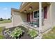 Charming front porch with decorative plants and cozy seating area at 4605 Clairmont Dr, Columbus, IN 47203
