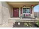 Inviting front porch features a cozy bench, vibrant plants, and decorative welcome sign at 4605 Clairmont Dr, Columbus, IN 47203
