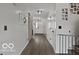 Well-lit hallway features hardwood floors, sliding barn door, and tasteful decor at 4605 Clairmont Dr, Columbus, IN 47203