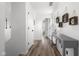 Bright hallway with modern gray console table and decorative wall art leading to various rooms at 4605 Clairmont Dr, Columbus, IN 47203