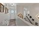 Bright hallway with hardwood floors leading to multiple rooms and decorative touches at 4605 Clairmont Dr, Columbus, IN 47203