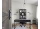 Stylish home office with modern desk, shelves, barn door, and neutral decor for a productive atmosphere at 4605 Clairmont Dr, Columbus, IN 47203