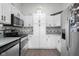 Spacious kitchen with stainless steel appliances, granite countertops and white cabinets at 4605 Clairmont Dr, Columbus, IN 47203