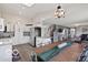 Bright, open-concept kitchen with white cabinets and modern lighting flowing into living and dining areas at 4605 Clairmont Dr, Columbus, IN 47203