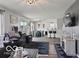 Cozy living room with comfortable seating, a modern entertainment center, and view into dining area at 4605 Clairmont Dr, Columbus, IN 47203