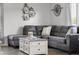 Comfortable living room with gray sectional sofa and modern farmhouse coffee table, perfect for relaxation at 4605 Clairmont Dr, Columbus, IN 47203
