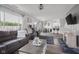 Open-concept living room with modern furnishings flowing into dining area and kitchen at 4605 Clairmont Dr, Columbus, IN 47203