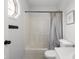 Bright bathroom features a combined shower tub with a curtain and white fixtures at 4605 Clairmont Dr, Columbus, IN 47203