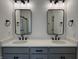 Bright bathroom featuring a double vanity, modern fixtures, and sleek mirrors at 473 Mariposa Trl, Carmel, IN 46032