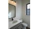 Modern bathroom features a vanity with white quartz countertop and black hardware at 473 Mariposa Trl, Carmel, IN 46032