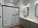 Modern bathroom with black framed shower and black hardware with gray vanity at 473 Mariposa Trl, Carmel, IN 46032