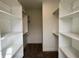 Walk-in closet featuring custom white shelving units and plenty of storage at 473 Mariposa Trl, Carmel, IN 46032