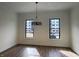 Spacious dining room featuring luxury vinyl plank floors and two large windows at 473 Mariposa Trl, Carmel, IN 46032