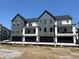 Modern multi-Gathering gray townhome exteriors with attached garages at 473 Mariposa Trl, Carmel, IN 46032