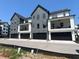 Multi-Gathering gray townhome exteriors with attached garages on a new development at 473 Mariposa Trl, Carmel, IN 46032