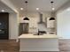 Bright kitchen with stainless steel appliances, white cabinets, and a central island at 473 Mariposa Trl, Carmel, IN 46032