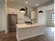 Modern kitchen with stainless steel appliances, white cabinets, and a central island at 473 Mariposa Trl, Carmel, IN 46032