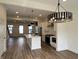 Contemporary open concept with eat-in kitchen, luxury vinyl plank flooring and recessed lighting at 473 Mariposa Trl, Carmel, IN 46032