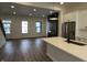 Open-concept living space featuring luxury vinyl plank flooring, recessed lighting and a modern fireplace at 473 Mariposa Trl, Carmel, IN 46032