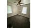 Bedroom with two windows, ceiling fan, and drab carpet at 4931 Orion Ave, Indianapolis, IN 46201