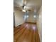 Spacious bedroom with gleaming hardwood floors, natural light, and ceiling fan at 4931 Orion Ave, Indianapolis, IN 46201