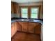 Kitchen features oak cabinets, stainless steel sink, and window views at 4931 Orion Ave, Indianapolis, IN 46201