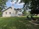View of the backyard showing a brick fire pit, hot tub, and fenced in yard at 530 Denny Dr, Mooresville, IN 46158
