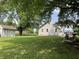 Spacious backyard with mature trees, storage shed, hot tub, and fire pit at 530 Denny Dr, Mooresville, IN 46158