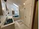 Bathroom with a large vanity sink and a jacuzzi tub, complimented by a skylight at 530 Denny Dr, Mooresville, IN 46158