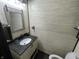 Bathroom with wood wall paneling, granite sink and vanity and dark wood door at 530 Denny Dr, Mooresville, IN 46158