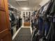 Walk-in closet with racks of clothing and shoes at 530 Denny Dr, Mooresville, IN 46158