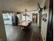 Open concept dining room with wood floors and large table in between kitchen and living room at 530 Denny Dr, Mooresville, IN 46158