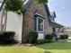Close-up exterior detail of the home with brick accents and tidy landscaping at 530 Denny Dr, Mooresville, IN 46158