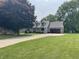 Exterior view of the home with a long driveway and mature trees at 530 Denny Dr, Mooresville, IN 46158