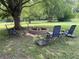 A lovely backyard features a brick fire pit and outdoor seating under a large shade tree at 530 Denny Dr, Mooresville, IN 46158