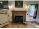 Living room fireplace with mounted TV and decorations at 530 Denny Dr, Mooresville, IN 46158