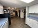 Open floor plan with wood floors connecting kitchen with white cabinets to dining room at 530 Denny Dr, Mooresville, IN 46158