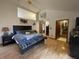 Spacious main bedroom with a king-size bed, vaulted ceilings, wood flooring, and ample closet space at 530 Denny Dr, Mooresville, IN 46158