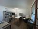 Well-lit home office featuring multiple desks, chair, and shelving at 530 Denny Dr, Mooresville, IN 46158