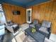 Relaxing screened-in porch with wood paneling, comfortable seating, and a television at 530 Denny Dr, Mooresville, IN 46158