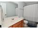 Standard bathroom with a wood-finished vanity, a large mirror, and a shower with a curtain at 5456 Reston Dr, Plainfield, IN 46168