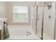 Bright bathroom features a soaking tub with a glass-enclosed shower and a large window at 5456 Reston Dr, Plainfield, IN 46168