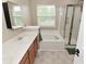 Bright bathroom featuring a soaking tub, glass-enclosed shower and a double-sink vanity at 5456 Reston Dr, Plainfield, IN 46168