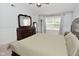 Bedroom showcasing a large dresser with mirror and abundant natural light from the nearby window at 5456 Reston Dr, Plainfield, IN 46168