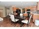 Bright dining area features a wooden table, modern chairs, and is attached to a modern kitchen at 5456 Reston Dr, Plainfield, IN 46168